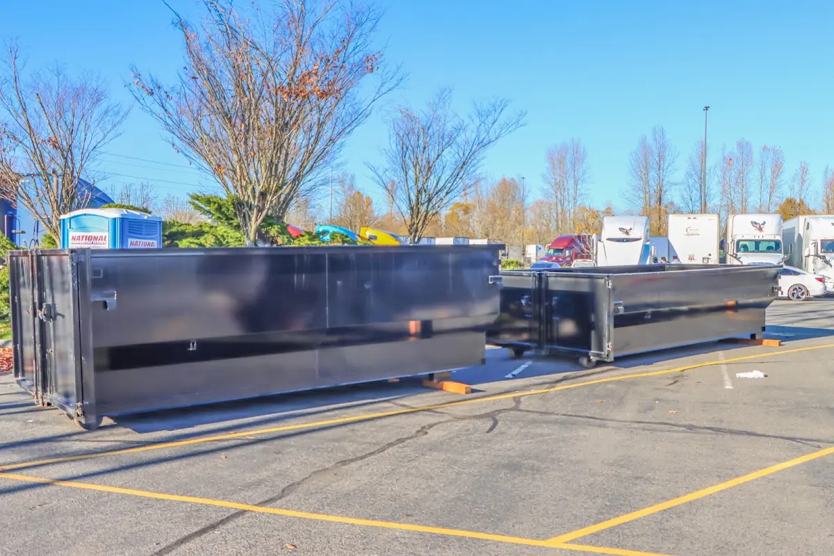 Professional dumpster rental service with roll-off container on residential driveway in Colville